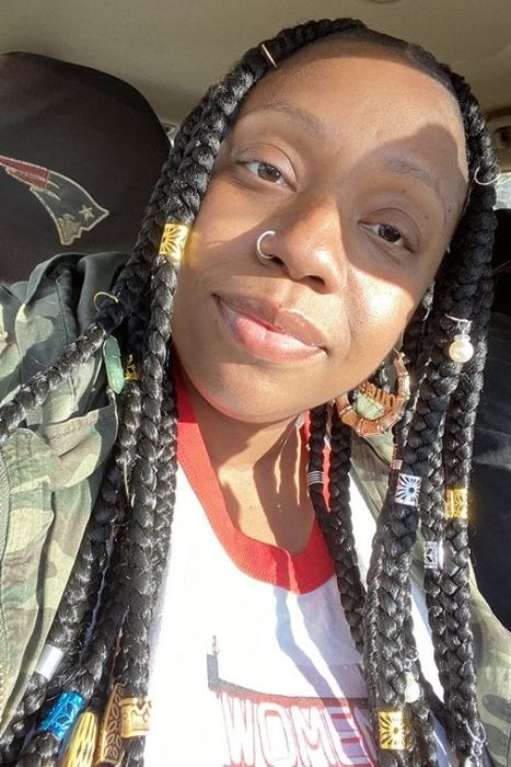 A reviewer wearing the braid and dreadlock accessories with style.