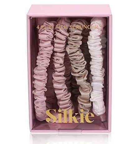 The set of mulberry silk hair ties in soft nude shades.