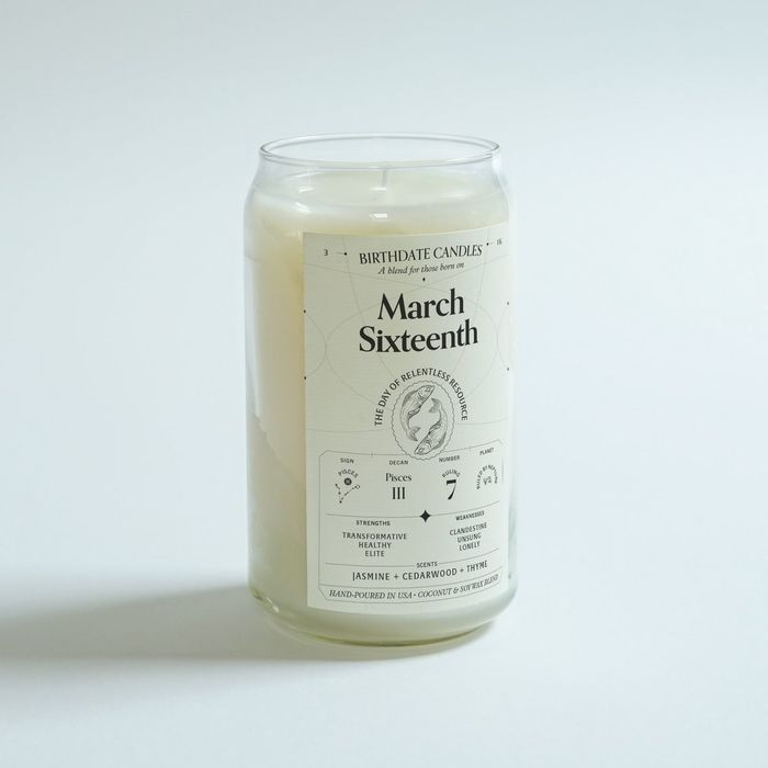 A hand-poured white candle in a jar with a label that reads "March Sixteenth"