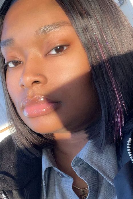 Reviewer photo featuring pink holographic hair tinsel styled in a short bob.