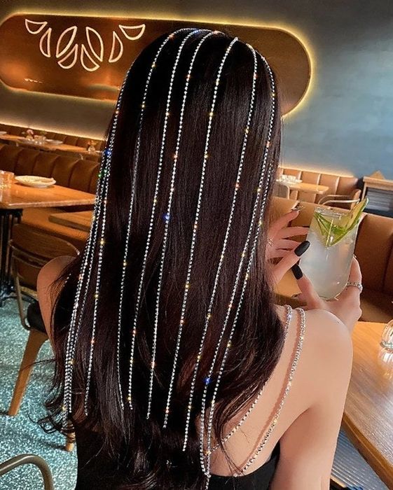 A model showcasing the long flash drill tassel headband.
