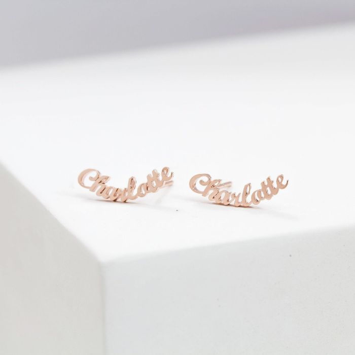 Two earrings featuring the name 