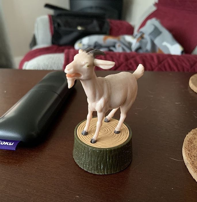 A photo of the screaming goat figurine on a desk, as captured by the reviewer.