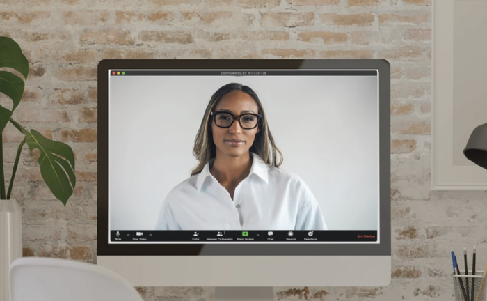 The model is displaying the top half of the robe on a computer screen, creating the appearance of a regular office shirt.