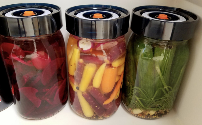 Three jars of freshly fermented beets, carrots, and cucumbers, ready to go.
