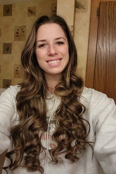 The same reviewer showing off their curly hair after using the satin curler.