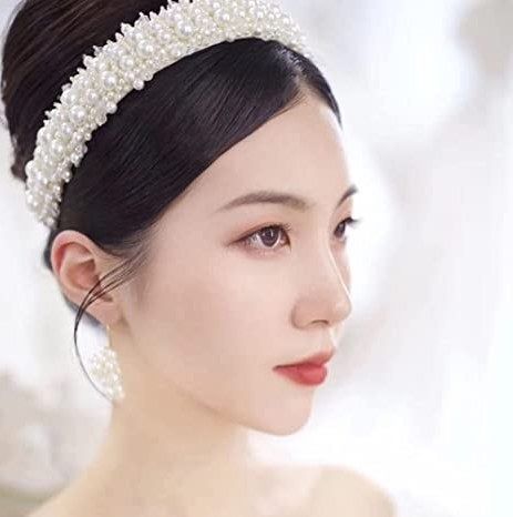 A model styling the pearl statement headband.