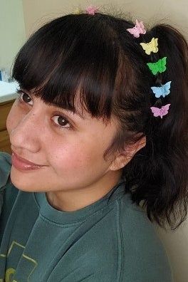 A reviewer showcasing the mini butterfly clip set in their hair
