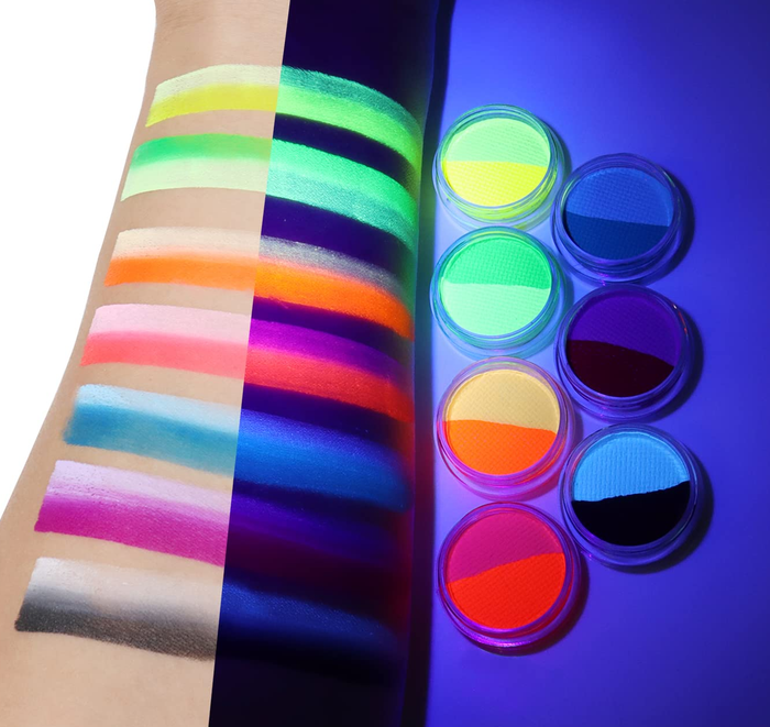 A model swatching all the eyeliner shades on their arm, showing how the colors pop under black light