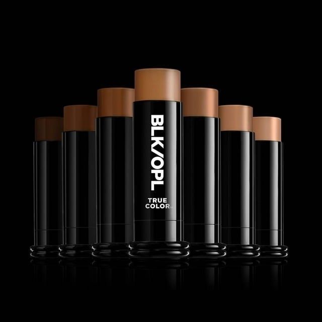A display of BLK/OPL foundation sticks in multiple shades against a dark backdrop