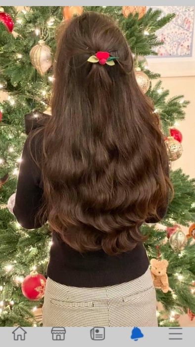 A reviewer’s photo showcasing their shiny, healthy brown hair.