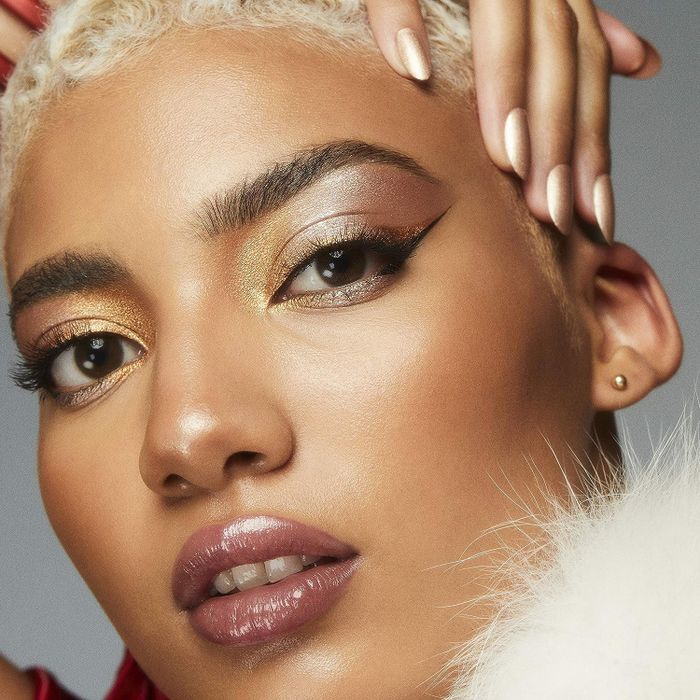 a model wearing eyeshadow in a radiant gold shade