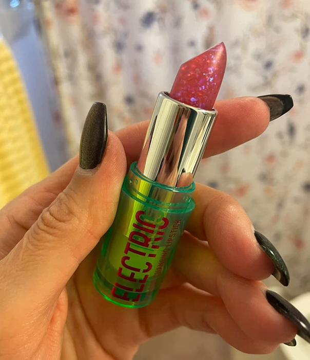 Image of a reviewer holding up the lipstick