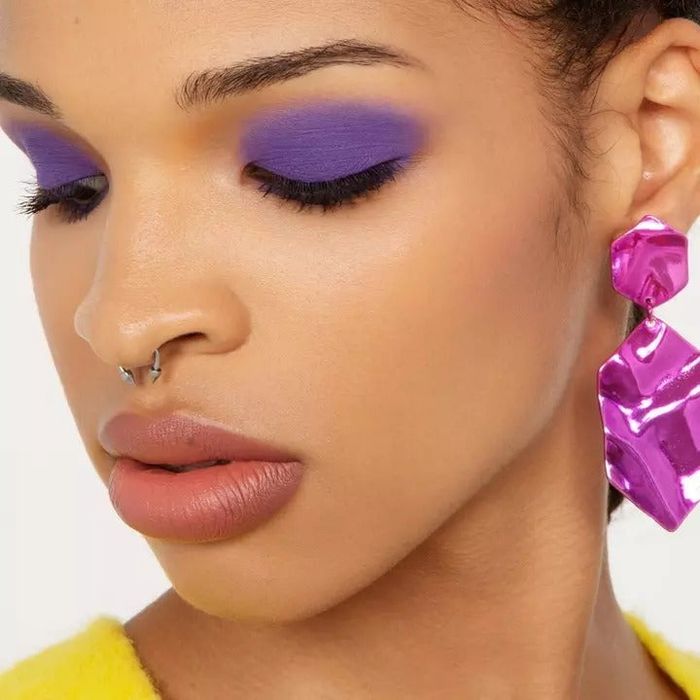 A model wearing purple eyeshadow