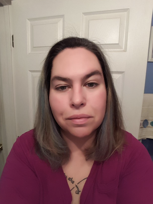 The same reviewer with their hair smoothed out after using the mask.