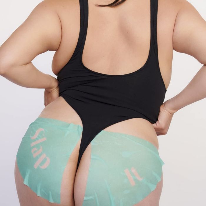 A model wearing two butt sheet masks, one labeled