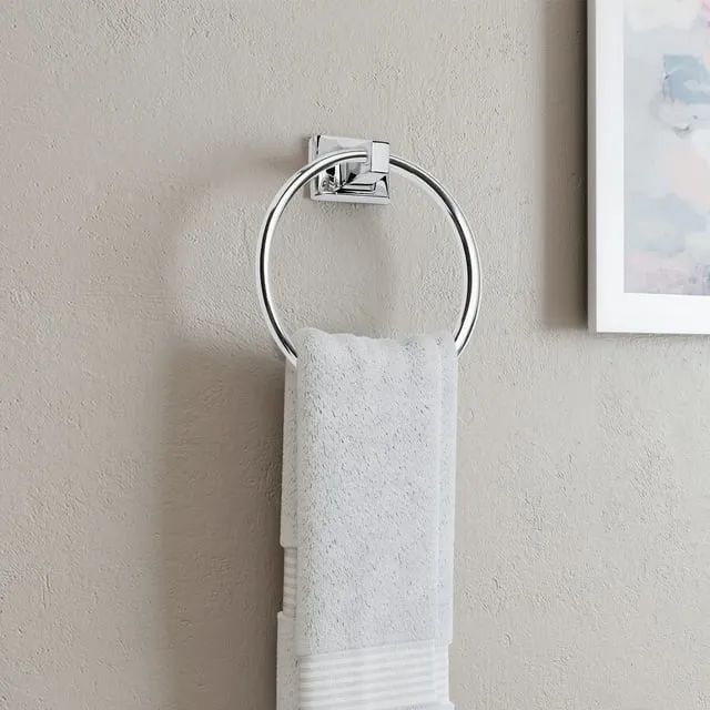 A sleek silver towel ring paired with a crisp white towel.