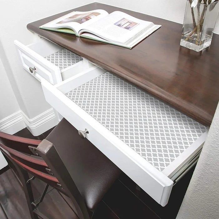The lattice-patterned shelf liner inside a desk drawer