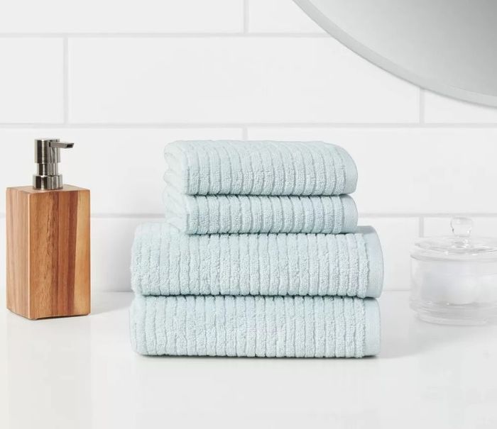 The set in aqua is designed to bring a refreshing touch of style to your bathroom. Soft and ribbed for a delightful texture, this towel set is made from 100% cotton, offering exceptional absorbency while being gentle on your skin. It's available in a two-pack, which includes two bath towels, or a four-pack with two bath towels and two hand towels.