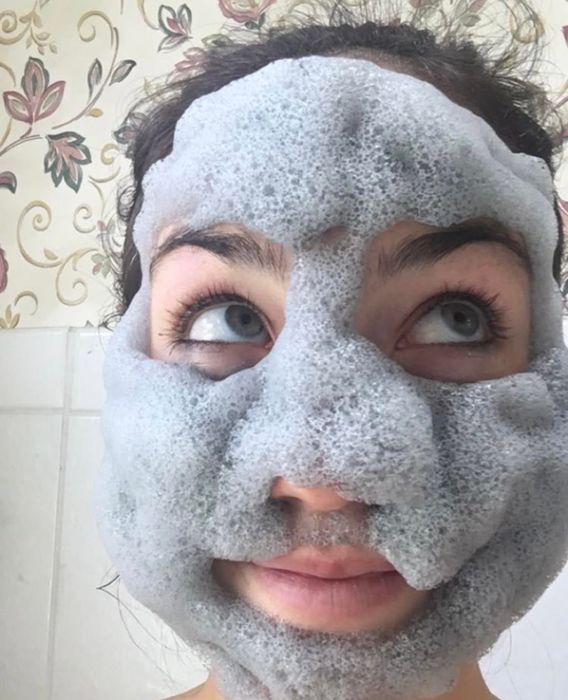 Reviewer applying the foaming facial mask