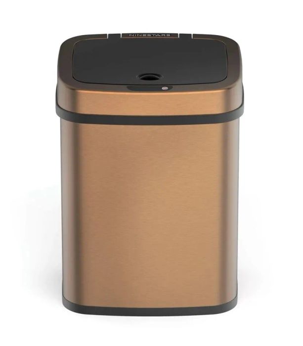A copper-toned, touchless bathroom waste bin.