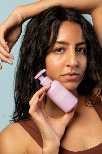 model holding the cleanser bottle