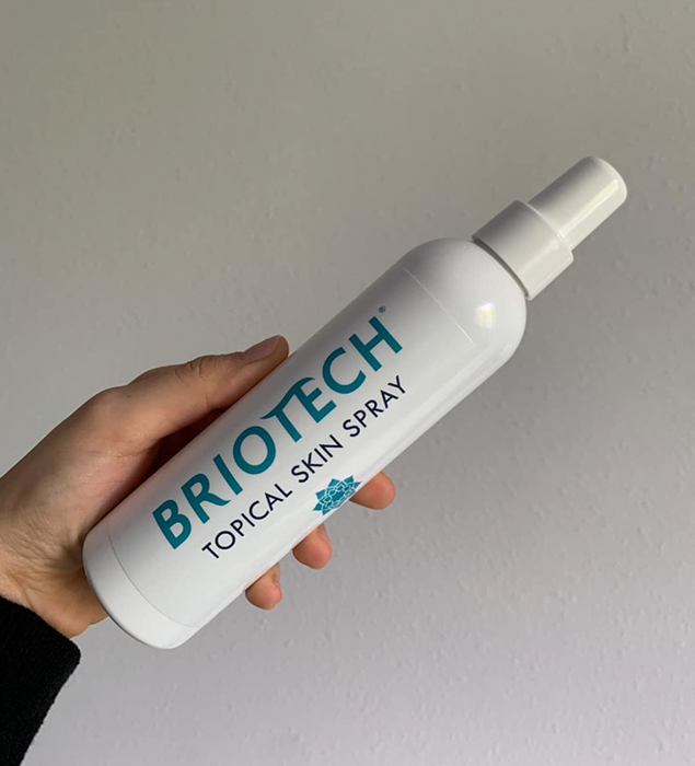 Reviewer holding their Briotech spray bottle, ready to soothe and protect their skin