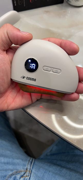 A reviewer holding the smart stone in their hand.