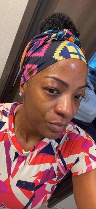 A reviewer showcasing glowing skin after using the toner.
