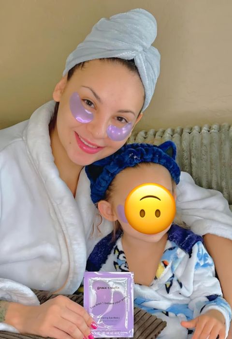reviewer and child both wearing purple under-eye patches