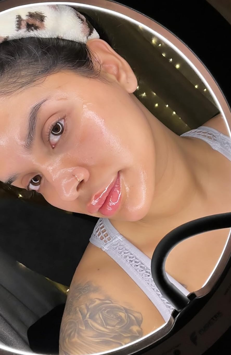 A reviewer showing off their glowing, glass-like skin.