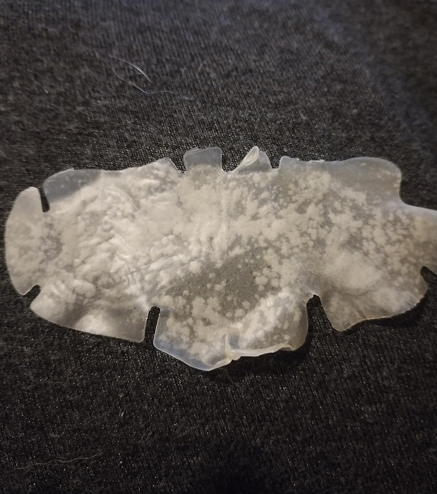 A reviewer's photo displaying a used nose strip with residue on it.