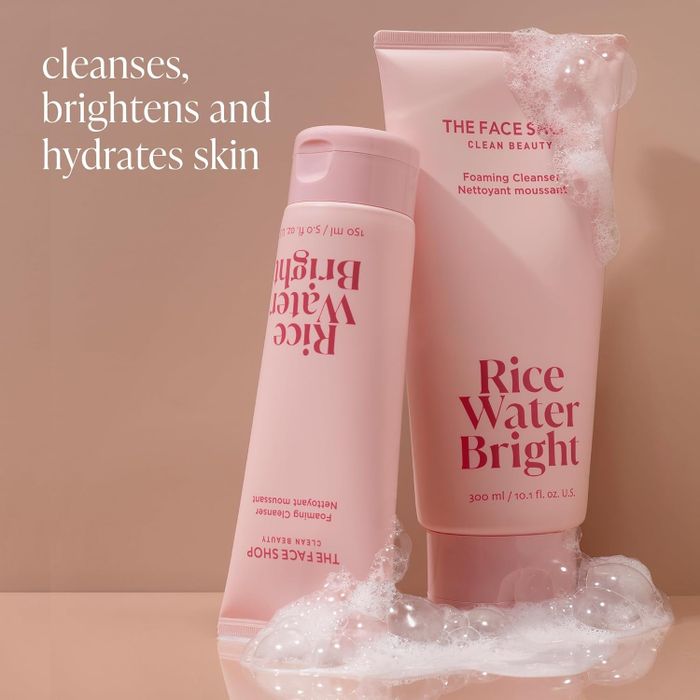 two pink bottles of the facial cleanser surrounded by bubbles