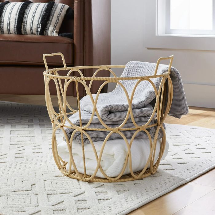 a wicker woven basket filled with neatly folded towels