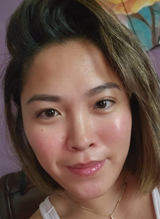 A reviewer showing off their glowing skin after applying the serum.
