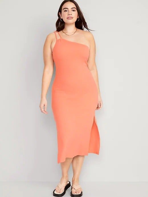 A model showcasing the tight-fitting one-shoulder dress in peach.