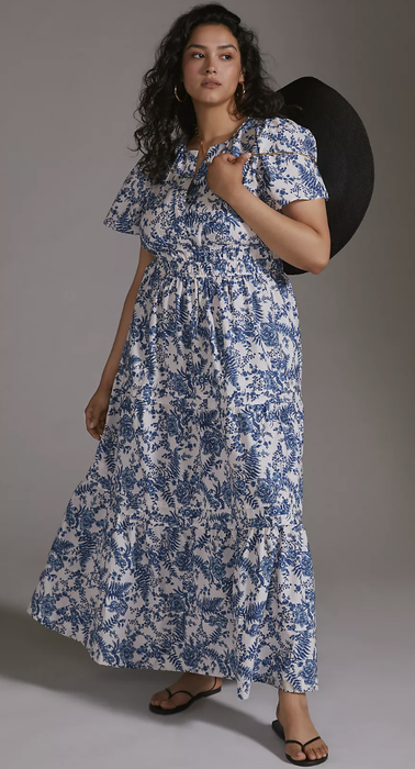 A model wearing a blue and white patterned maxi dress