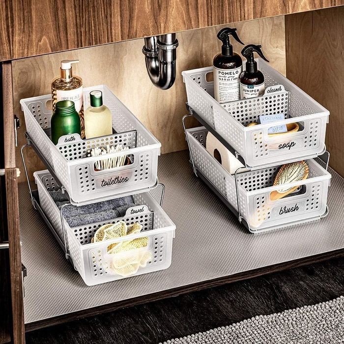 two storage towers with bath products neatly arranged underneath a sink