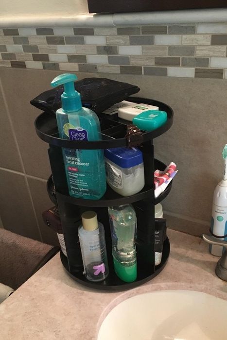 reviewer's black rotating organizer with various products neatly arranged on it