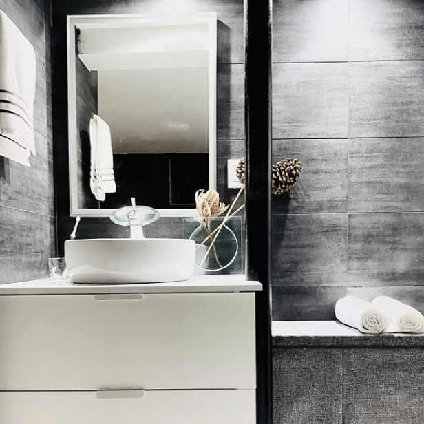 The same faucet shown from the front, offering a better view of the bathroom it’s installed in.