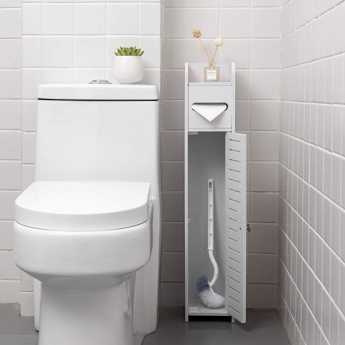grey storage tower with a cleaning brush neatly stored inside the compartment