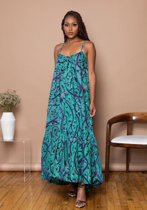 Model wearing a sleeveless aqua and purple maxi dress