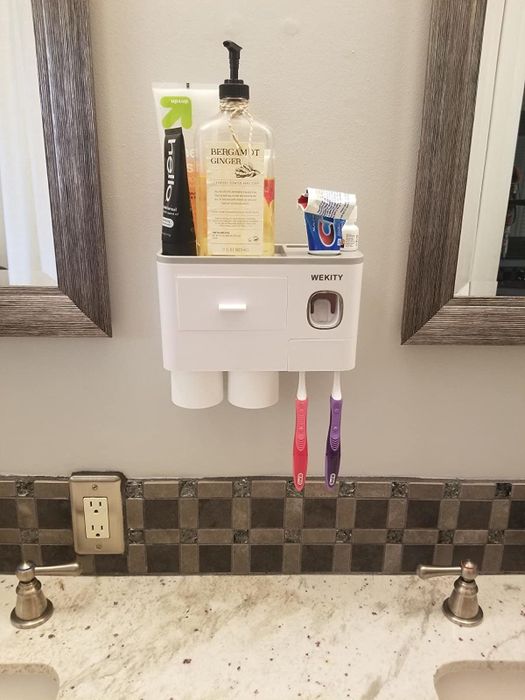 Reviewer using a bathroom shelf to organize products and toothpaste