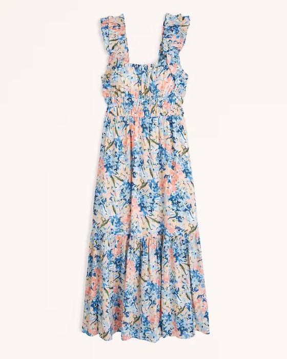 model showcasing the dress in a vibrant blue and pink floral pattern