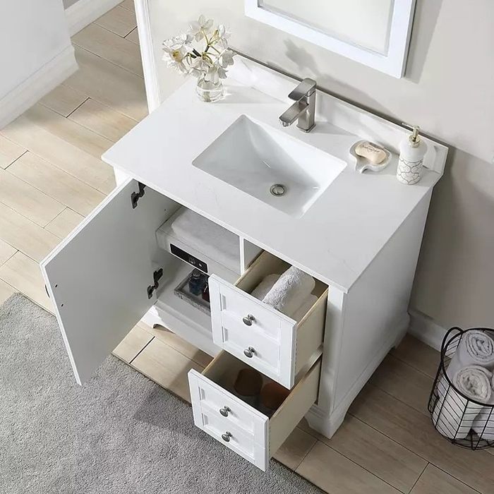 A sleek all-white vanity featuring two drawers, a cabinet, sink, and countertop.