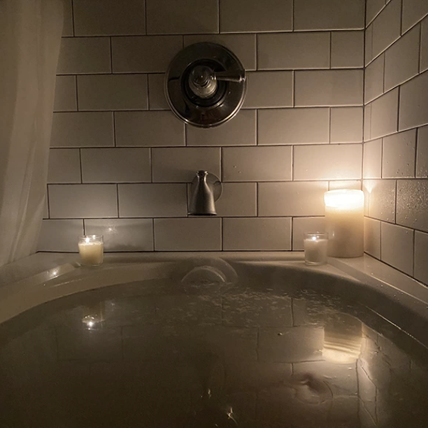 A reviewer's bathtub overflowing due to the cap covering the drain
