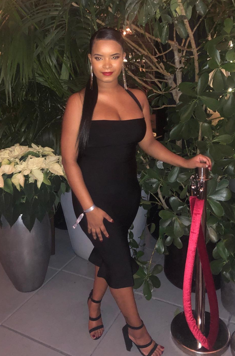 reviewer wearing the dress in an elegant black color