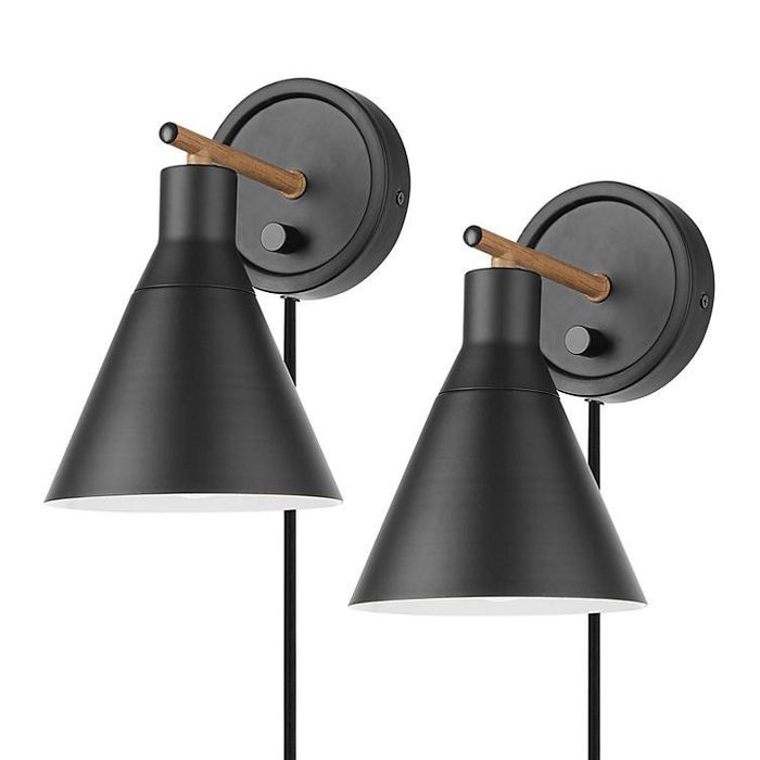 A pair of matte black and faux walnut bathroom light fixtures featuring a sleek cone design.