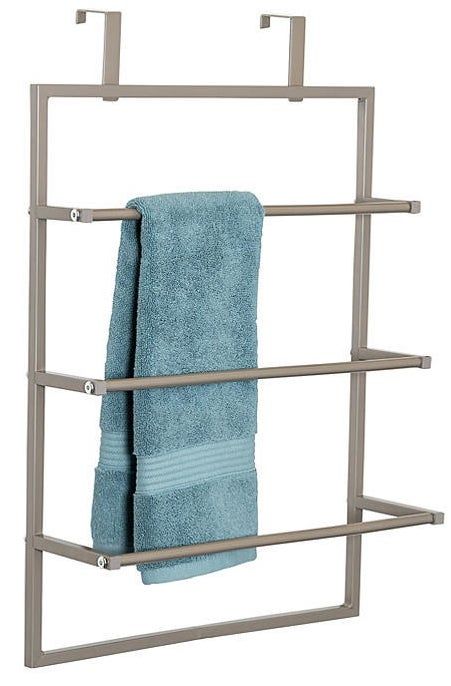 An over-the-door towel rack with a blue towel hanging on it.