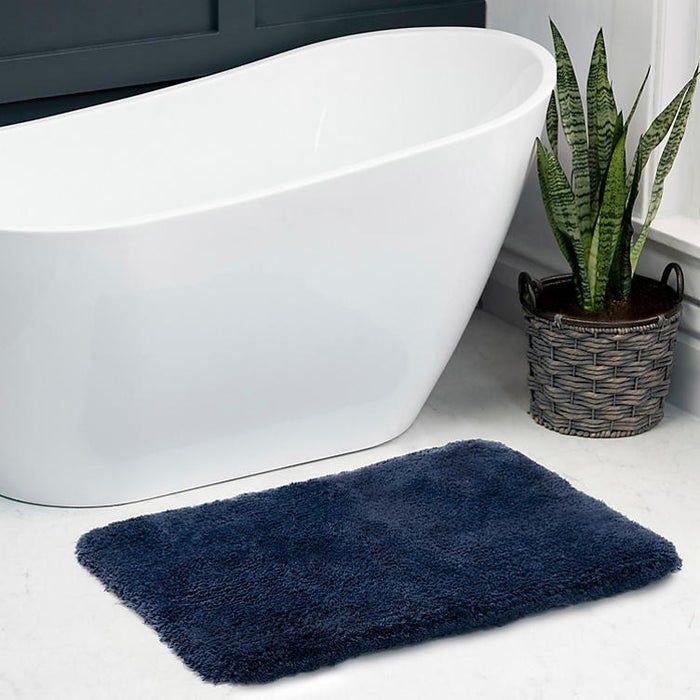 a wash indigo bath rug placed on the bathroom floor